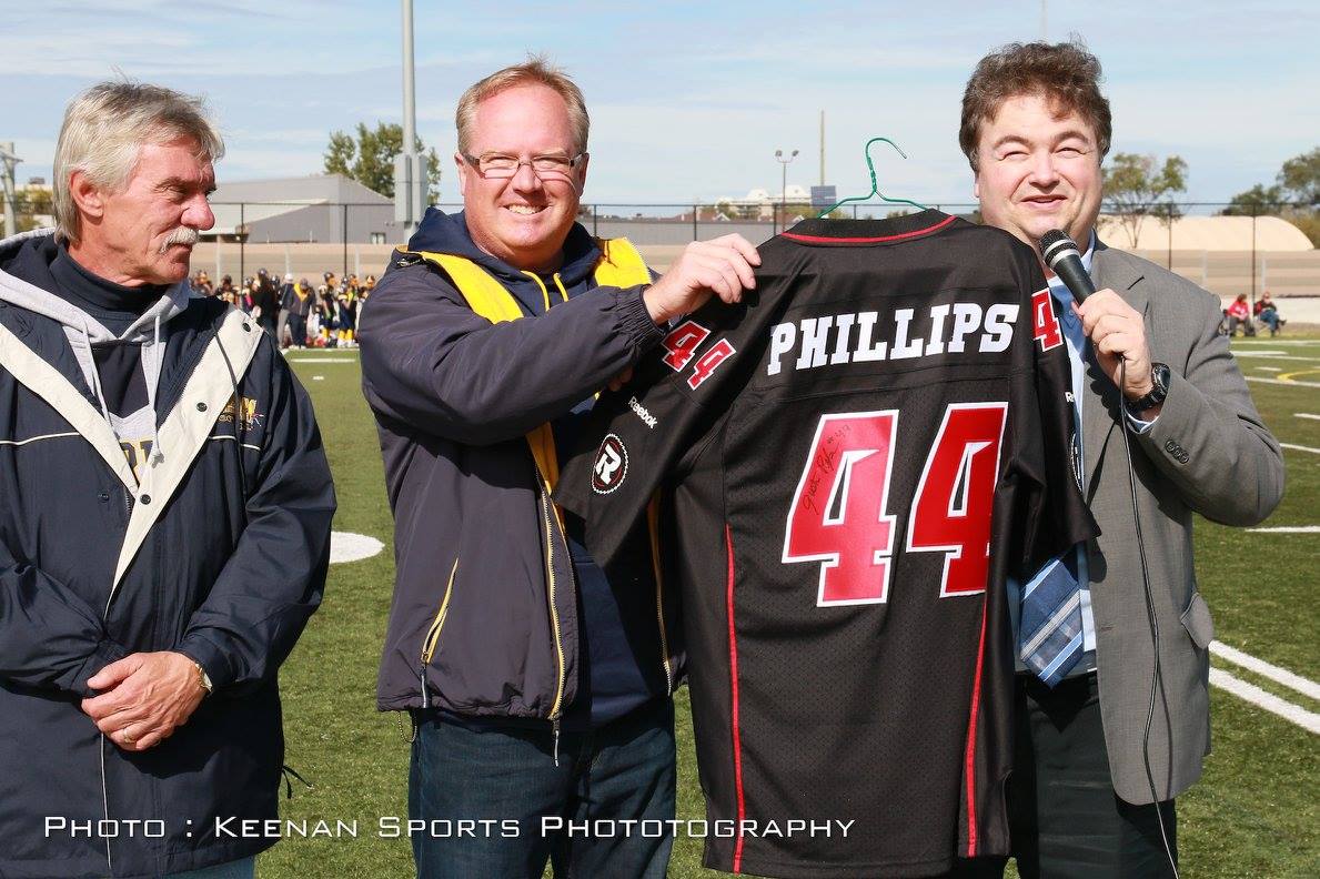 Pictured L to R: Jim Wagdin (Warriors Past-President); Paul Stewart (President); Rick Chiarelli (City of Ottawa College Ward Councillor) presenting signed Ottawa REDBLACKS jersey from Warrior alumni and REDBLACKS player Justin Phillips.